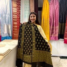 This shopping exhibition has silk sarees and dupattas on display.