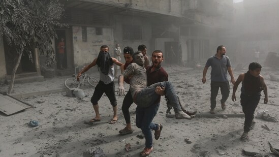 Israel-Hamas War: Palestinians evacuate a wounded man following Israeli airstrikes on Gaza City. (AP)