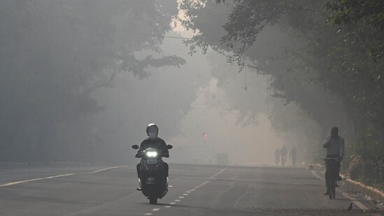 Commuters out on a smoggy morning amid rising air pollution near Mandi House in New Delhi on October 23. (Arvind Yadav/ Hindustan Times)