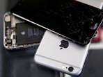 Broken Apple iPhones are seen in a repair shop.