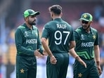 Pakistan's captain Babar Azam (L) talks with his teammate Haris Rauf.