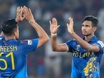Sri Lanka's Matheesha Pathirana (R) celebrates with teammate after taking the wicket of Pakistan's Abdullah Shafique 