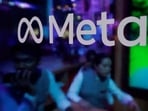 FILE PHOTO: People are seen behind a logo of Meta Platforms, during a conference in Mumbai, India, September 20, 2023. REUTERS/Francis Mascarenhas/File Photo