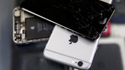 Broken Apple iPhones are seen in a repair shop. (REUTERS)