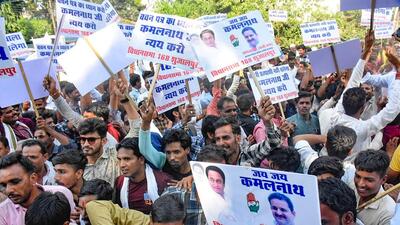 Congress supporters protest outside former chief minister Kamal Nath's residence. (ANI) Congress supporters protest outside former chief minister Kamal Nath's residence. (ANI)