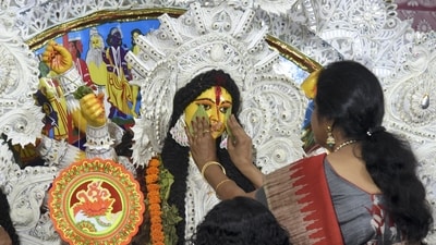 Meanwhile, Devi Boron is the ritual where Durga devotees bid adieu to the goddess by drawing a betel leaf on their palms and touching it to the deity's face, symbolically wiping the face of Maa Durga off any tears, as she prepares to leave her parents behind to join her husband. Sindoor is applied to her forehead first and then her bangles (shakha and pola), and sweets are offered. (PTI) Meanwhile, Devi Boron is the ritual where Durga devotees bid adieu to the goddess by drawing a betel leaf on their palms and touching it to the deity's face, symbolically wiping the face of Maa Durga off any tears, as she prepares to leave her parents behind to join her husband. Sindoor is applied to her forehead first and then her bangles (shakha and pola), and sweets are offered. (PTI)