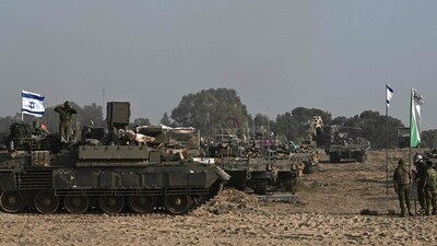 Israel-Hamas War: Israeli military armoured vehicles deploy along the Israeli-Gaza border. (AFP) Israel-Hamas War: Israeli military armoured vehicles deploy along the Israeli-Gaza border. (AFP)