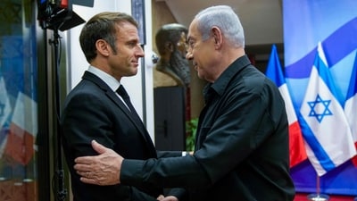 Israeli Prime Minister Benjamin Netanyahu (right) greets French President Emmanuel Macron in Jerusalem on October 24. (AFP) Israeli Prime Minister Benjamin Netanyahu (right) greets French President Emmanuel Macron in Jerusalem on October 24. (AFP)