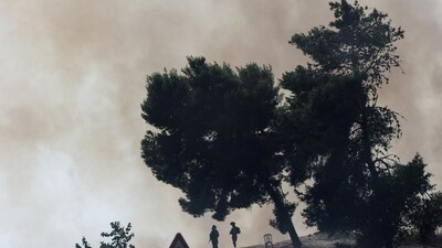Israel-Hamas War: Israeli soldiers stand guard and look at a fire that was caused when a rocket that was launched from Gaza landed in southern Israel. (Reuters)