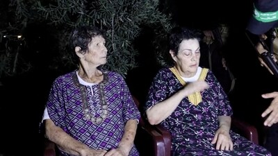 Yocheved Lifshitz and Nurit Cooper (also known as Nurit Yitzhak) who were held hostages by Palestinian Hamas militants, are released by the militants, in this video screengrab obtained by Reuters on October 23, 2023 (Al-Qassam Brigades, military wing of Hamas/Handout via REUTERS) (via REUTERS)