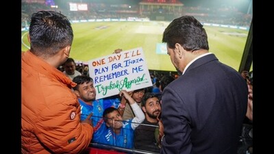 Anurag Thakur reading a placard held up by a cricket enthusiast during India vs New Zealand match in Dharamshala on October 22. (X/@ianuragthakur) Anurag Thakur reading a placard held up by a cricket enthusiast during India vs New Zealand match in Dharamshala on October 22. (X/@ianuragthakur)