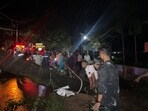 Bangladeshi men cut a fallen tree to clear a blocked road in Cox's Bazar in the early hours after the landfall of cyclone Hamoon. Bangladeshi men cut a fallen tree to clear a blocked road in Cox's Bazar in the early hours after the landfall of cyclone Hamoon.