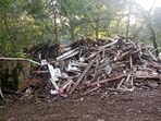 In this photo provided by Susan Hodgson, her mistakenly demolished family home sits in a pile of lumber and debris in southwest Atlanta, Georgia, on Sept. 15, 2023. (Susan Hodgson via AP)