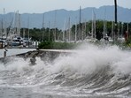 Waves crash against an ocean pier as Hurricane barrels towards Mexico's Pacific coast