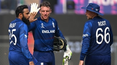 England's Adil Rashid (L) celebrates with teammate Joe Root (R) and captain Jos Buttler after taking the wicket of South Africa's Rassie van der Dussen (AFP) England's Adil Rashid (L) celebrates with teammate Joe Root (R) and captain Jos Buttler after taking the wicket of South Africa's Rassie van der Dussen (AFP)
