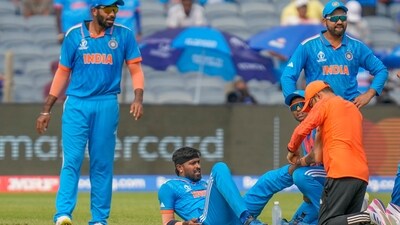 Team physio attends to India's Hardik Pandya, second left, after sustaining an injury during the ICC Men's Cricket World Cup match between India and Bangladesh in Pune (AP) Team physio attends to India's Hardik Pandya, second left, after sustaining an injury during the ICC Men's Cricket World Cup match between India and Bangladesh in Pune (AP)