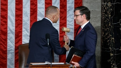 U.S. House Minority Leader Hakeem Jeffries (D-NY) (L) hands the gavel to newly elected Speaker of the House Mike Johnson (R-LA) after the House of Representatives held an election in the U.S. Capitol on October 25, 2023 in Washington, DC. (Getty Images via AFP)