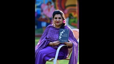 Internationally acclaimed author Lily Swarn with her latest book, The Divine Dialect of Flowers, at Chandigarh Press Club on Thursday. (Photo: Keshav Singh/HT)