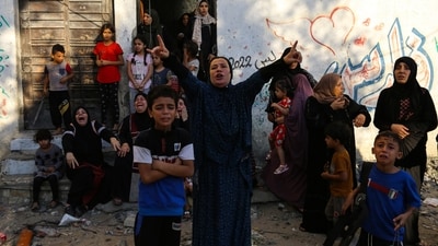 FILE - Palestinian women and children react following Israeli airstrikes targeting their neighbourhood in Gaza City, Saturday, Oct. 21, 2023. (AP Photo/Abed Khaled, File) (AP)
