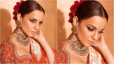 For her makeup look, Kangana wore winged eyeliner, kohl eyes, shimmery eyeshadow, contoured cheeks and a nude shade of lipstick. Her hair was styled in a centre parted bun and adorned with red roses to round off her glam look. (Instagram/@kanganaranaut) For her makeup look, Kangana wore winged eyeliner, kohl eyes, shimmery eyeshadow, contoured cheeks and a nude shade of lipstick. Her hair was styled in a centre parted bun and adorned with red roses to round off her glam look. (Instagram/@kanganaranaut)