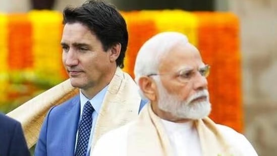 Canada’s Prime Minister Justin Trudeau, left, walks past Prime Minister Narendra Modi as they take part in a wreath-laying ceremony at Raj Ghat, Mahatma Gandhi’s cremation site, during the G20 Summit on Sept. 10 (AP file photo.)