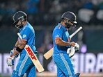 India's Virat Kohli arrives to bat as team's captain Rohit Sharma (R) walks back to the pavilion India's Virat Kohli arrives to bat as team's captain Rohit Sharma (R) walks back to the pavilion