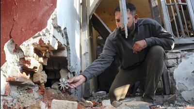 A man holds a mortar shell fired by the Pakistan Rangers at a village in Jammu on Friday. (PTI) A man holds a mortar shell fired by the Pakistan Rangers at a village in Jammu on Friday. (PTI)