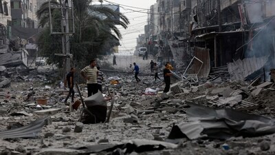 Palestinians inspect the damage of destroyed buildings following Israeli airstrikes on Gaza City. (AP) Palestinians inspect the damage of destroyed buildings following Israeli airstrikes on Gaza City. (AP)