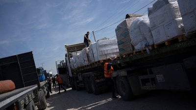 Trucks with humanitarian aid for the 'Gaza Strip enter from Egypt in Rafah on Saturday. (AP) Trucks with humanitarian aid for the 'Gaza Strip enter from Egypt in Rafah on Saturday. (AP)