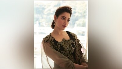 Tamannaah's blouse has a crew neckline, a fitted silhouette, and a short hem length. While the skirt has a pleated design and an asymmetric hem, the jacket features an open front, billowy full-length sleeves, and a sheer see-through design.&nbsp; (Instagram)