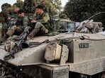 Israel-Hamas War: Israeli army soldiers sit atop a tracked vehicle at a position in the upper Galilee region of northern Israel. Israel-Hamas War: Israeli army soldiers sit atop a tracked vehicle at a position in the upper Galilee region of northern Israel.