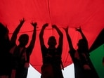 Israel-Hamas War: Protesters hold a giant Palestinian flag during a protest.
