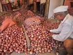 A worker sorts onions at an APMC market as onion prices soar across the country.