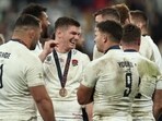 England's fly-half Owen Farrell (C) reacts with teammates during the medal ceremony after the  France 2023 Rugby World Cup third-place match vs Argentina