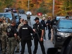 BOWDOIN, MAINE - OCTOBER 26: Law enforcement officials gather in the road leading to the home of the suspect being sought in connection with two mass shootings on October 26, 2023 in Bowdoin, Maine. Police are searching for U.S. Army Reservist Robert Card, 40, who is wanted in the shooting deaths of 18 people at a bowling alley and a bar last night in nearby Lewiston. At least 13 others were wounded in the rampage. Joe Raedle/Getty Images/AFP (Photo by JOE RAEDLE / GETTY IMAGES NORTH AMERICA / Getty Images via AFP) BOWDOIN, MAINE - OCTOBER 26: Law enforcement officials gather in the road leading to the home of the suspect being sought in connection with two mass shootings on October 26, 2023 in Bowdoin, Maine. Police are searching for U.S. Army Reservist Robert Card, 40, who is wanted in the shooting deaths of 18 people at a bowling alley and a bar last night in nearby Lewiston. At least 13 others were wounded in the rampage. Joe Raedle/Getty Images/AFP (Photo by JOE RAEDLE / GETTY IMAGES NORTH AMERICA / Getty Images via AFP)