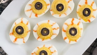Deviled Egg Eyeballs: For a spooky Halloween appetizer, prepare Deviled Egg Eyeballs by adorning deviled eggs with olive slices for the irises and red pepper strips for bloodshot veins.&nbsp; (Pinterest)