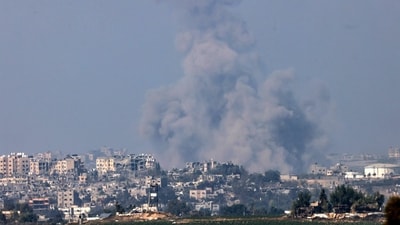 A picture taken from the southern Israeli city of Sderot shows smoke ascending over the northern Gaza Strip following an Israeli strike on October 25, 2023, amid the ongoing battles between Israel and the Palestinian group Hamas. (Photo by RONALDO SCHEMIDT / AFP) (AFP) A picture taken from the southern Israeli city of Sderot shows smoke ascending over the northern Gaza Strip following an Israeli strike on October 25, 2023, amid the ongoing battles between Israel and the Palestinian group Hamas. (Photo by RONALDO SCHEMIDT / AFP) (AFP)