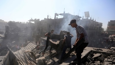 Palestinians inspect the rubble of destroyed buildings following Israeli airstrikes on town of Khan Younis, southern Gaza Strip on October 26. (AP) Palestinians inspect the rubble of destroyed buildings following Israeli airstrikes on town of Khan Younis, southern Gaza Strip on October 26. (AP)