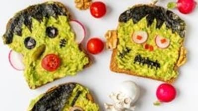 Monster Avocado Toasts: Create spooky-themed Monster Avocado Toasts by spreading avocado on toast and adding cherry tomato eyes, olive or red bell pepper pupils, and a creepy or silly red bell pepper smile.&nbsp; (Pinterest)