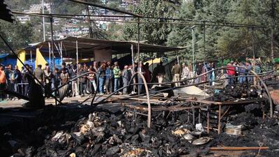 People at the venue of the international Dussehra festival in Kullu, where tents and makeshift shops, were destroyed in a fire early on Saturday. (Aqil Khan/HT) People at the venue of the international Dussehra festival in Kullu, where tents and makeshift shops, were destroyed in a fire early on Saturday. (Aqil Khan/HT)