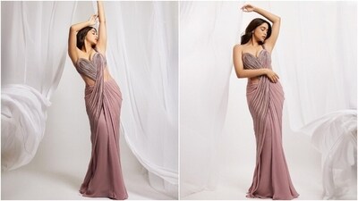 Sharvari's mauve saree gown features sequin embellishments, a heart-shaped structure on the front, a corseted bodice, a plunging neckline, a strapless silhouette with an attached pallu falling from the shoulder, and a figure-sculpting silhouette highlighting her frame. (Instagram) Sharvari's mauve saree gown features sequin embellishments, a heart-shaped structure on the front, a corseted bodice, a plunging neckline, a strapless silhouette with an attached pallu falling from the shoulder, and a figure-sculpting silhouette highlighting her frame. (Instagram)