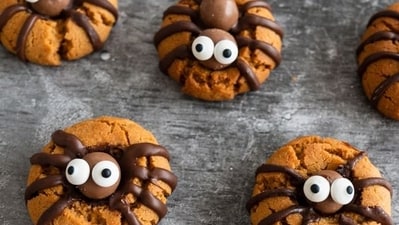 Spider Halloween Cookies: Make Spider Halloween Cookies by decorating round cookies with black icing to create spider bodies and adding black liquorice or pretzel sticks as legs for a spooky Halloween treat.&nbsp; (Pinterest)