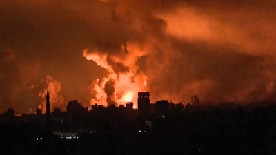 Footage shows balls of fire and smoke rising above Gaza City during an Israeli strike on October 27, 2023, as battles between Israel and the Palestinian Hamas movement continue. (AFP) Footage shows balls of fire and smoke rising above Gaza City during an Israeli strike on October 27, 2023, as battles between Israel and the Palestinian Hamas movement continue. (AFP)