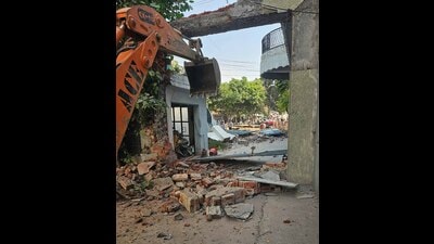 The municipal corporation team removing an encroachment on a public street in Kailash Nagar, Ludhiana. (HT PHOTO)