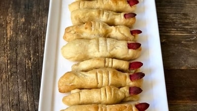 Witch Finger Pretzels: Make Witch Finger Pretzels by coating pretzel rods in green-tinted almond bark and using sliced almonds as "nails" to create eerie witch fingers for a Halloween snack.&nbsp; (Pinterest)
