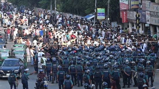 Bangladesh Protests: Police (front) stand guard in front of Bangladesh Nationalist party (BNP) activists during a rally. (AFP)