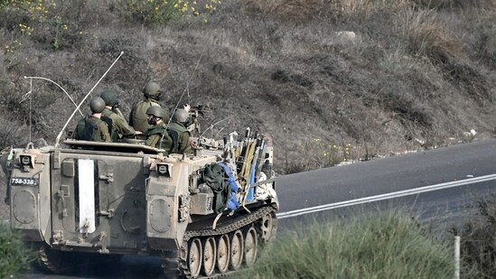 Israel-Hamas War: Israeli soldiers ride an armoured vehicle along a road on the outskirts of the southern Israeli city of Sderot. (AFP)
