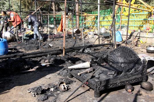 Fire department personnel said 13 tents of deities, a vehicle and five shops were burnt to ashes. (Aqil Khan/HT) Fire department personnel said 13 tents of deities, a vehicle and five shops were burnt to ashes. (Aqil Khan/HT)