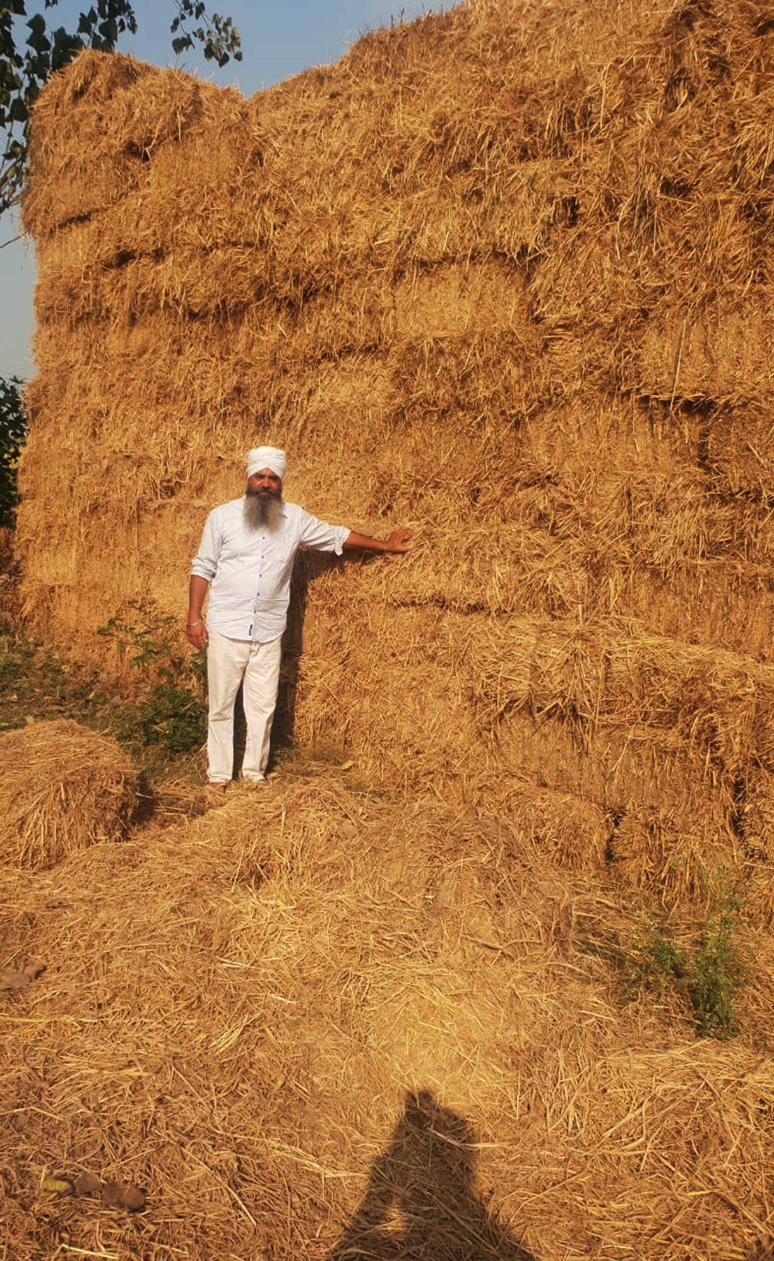 Attar Singh with bales at Sohal village in district Gurdaspur. (Sameer Sehgal /HT) Attar Singh with bales at Sohal village in district Gurdaspur. (Sameer Sehgal /HT)