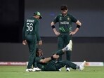 Pakistan's Mohammad Wasim Jr. reacts after sustaining an injury as Babar Azam and Shaheen Afridi watch 